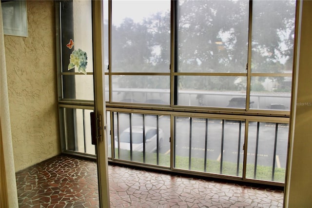 unfurnished sunroom featuring a wealth of natural light