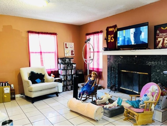 tiled living room with a textured ceiling and a fireplace