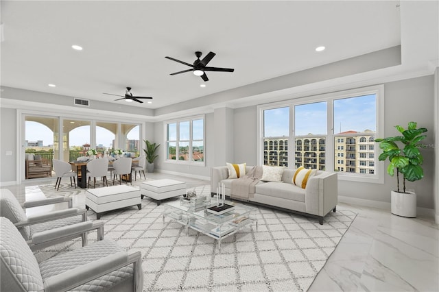 tiled living room featuring ceiling fan