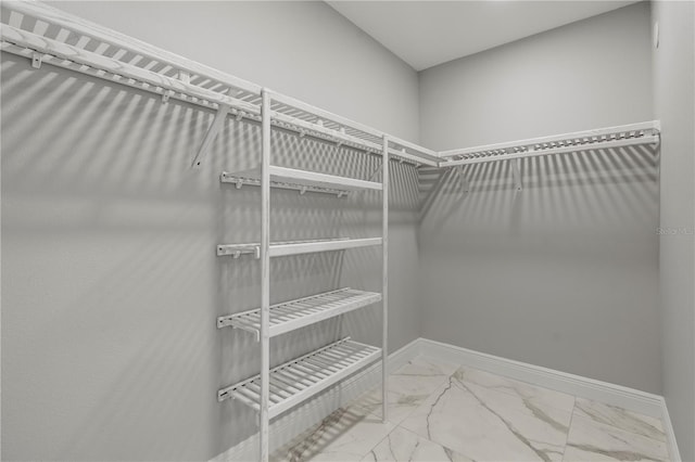 walk in closet with tile floors