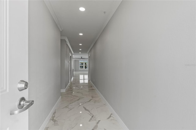 hall with crown molding and light tile flooring