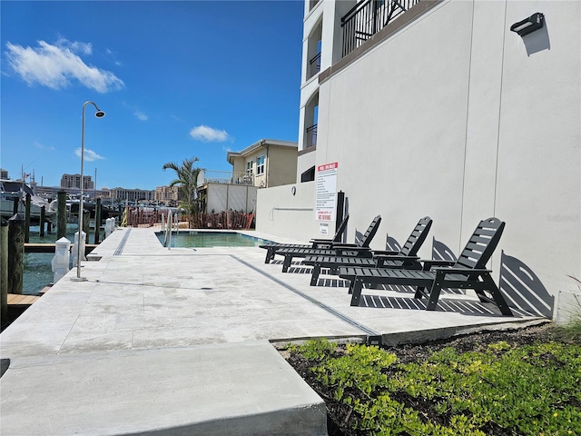 exterior space featuring a dock and a community pool