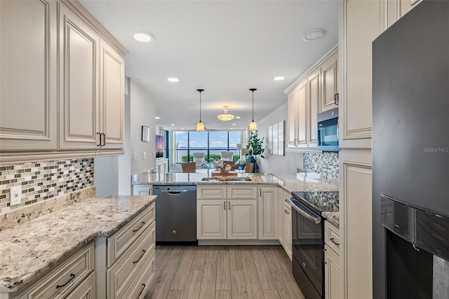 kitchen with kitchen peninsula, decorative light fixtures, backsplash, appliances with stainless steel finishes, and light hardwood / wood-style flooring