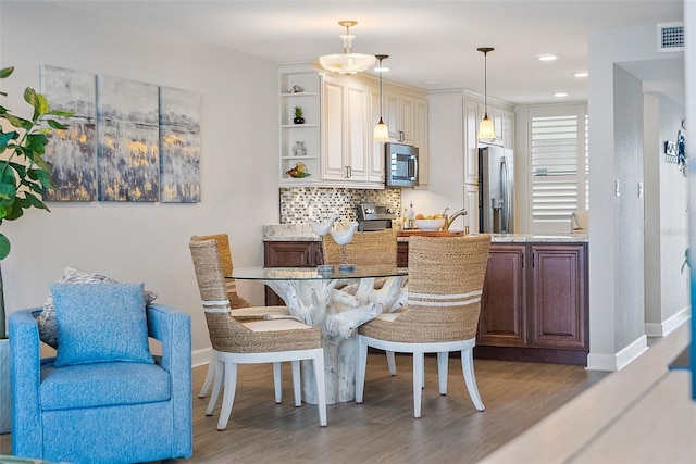 dining space with dark hardwood / wood-style floors