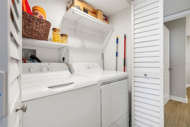 clothes washing area featuring hookup for a washing machine, light hardwood / wood-style floors, and washing machine and clothes dryer