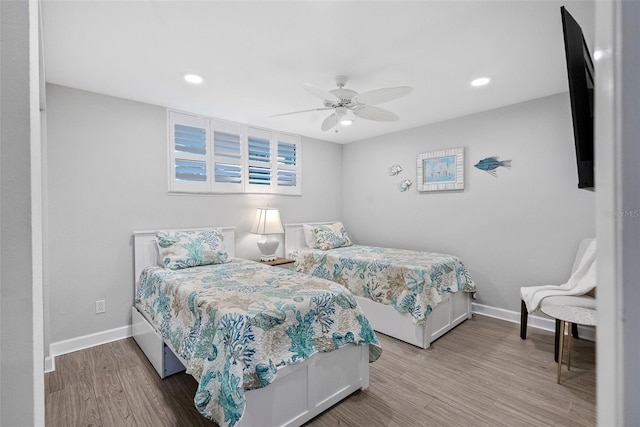 bedroom with ceiling fan and hardwood / wood-style flooring