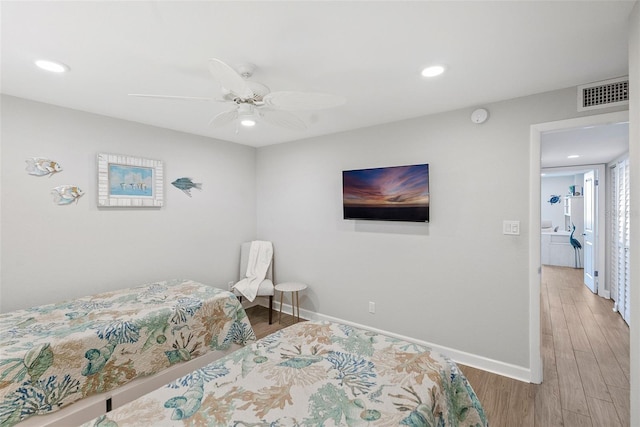 bedroom with light hardwood / wood-style flooring and ceiling fan