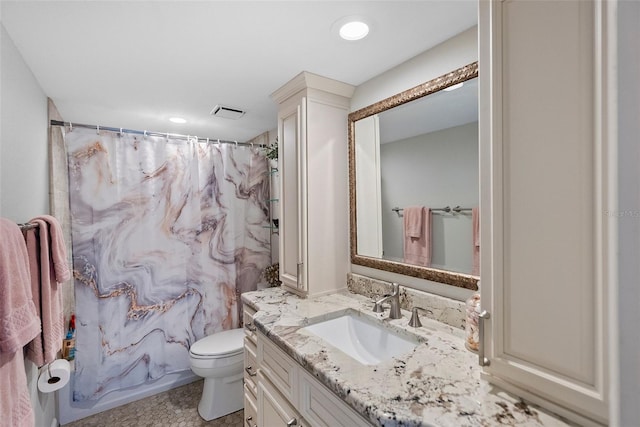 bathroom featuring toilet and vanity