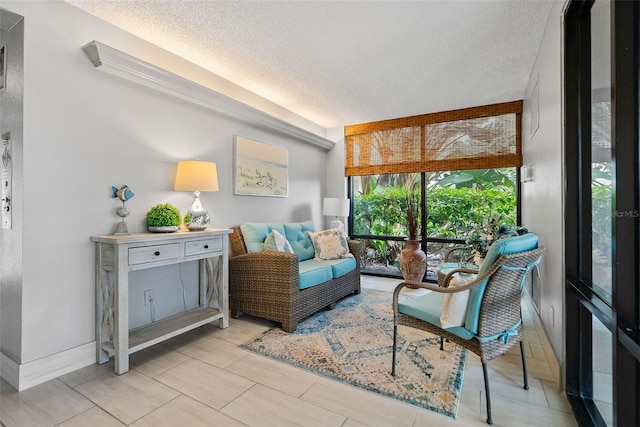 living area featuring light tile floors and a textured ceiling