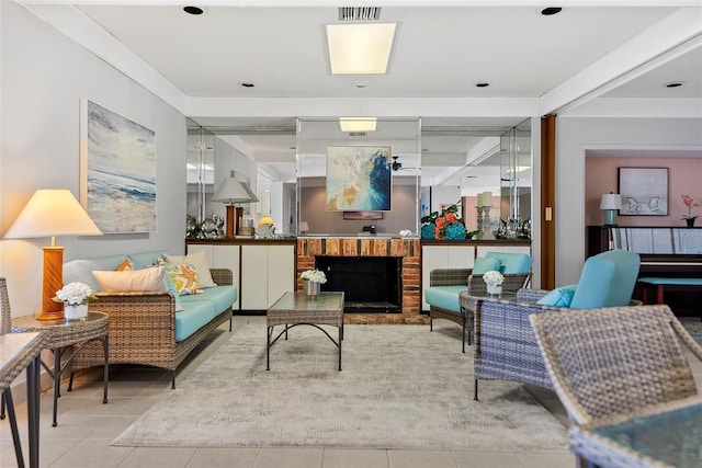 interior space featuring a brick fireplace and light tile floors