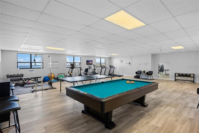 recreation room with light hardwood / wood-style floors, a healthy amount of sunlight, pool table, and a paneled ceiling