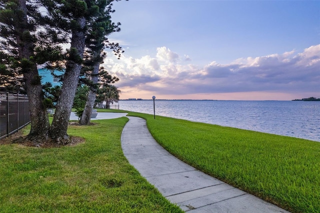 view of home's community featuring a yard and a water view