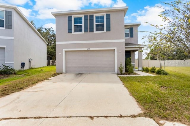 view of property with a front lawn and a garage