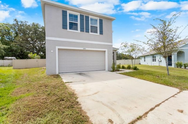 view of property with a front lawn and a garage