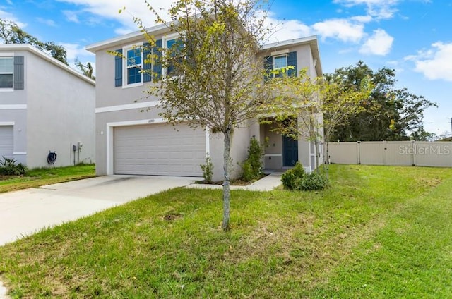 view of front of home with a front yard and a garage