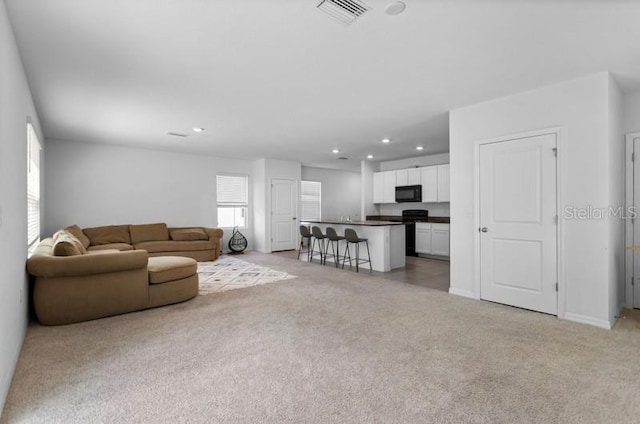 unfurnished living room featuring light carpet