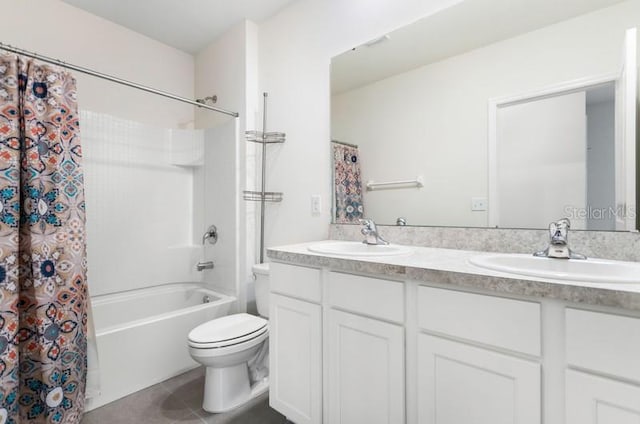 full bathroom with dual vanity, tile floors, shower / tub combo with curtain, and toilet