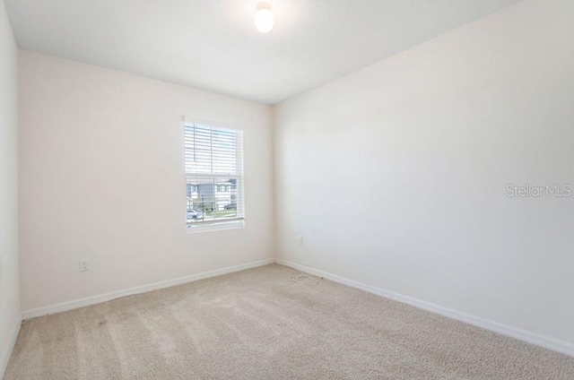 empty room featuring light carpet