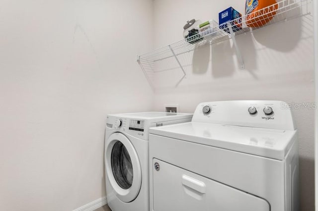 laundry room featuring washing machine and clothes dryer