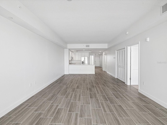 unfurnished living room with wood-type flooring