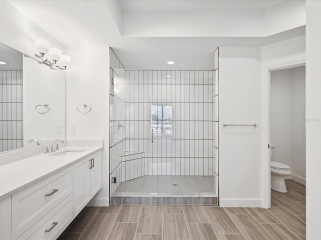 bathroom featuring toilet, tile floors, an enclosed shower, and vanity