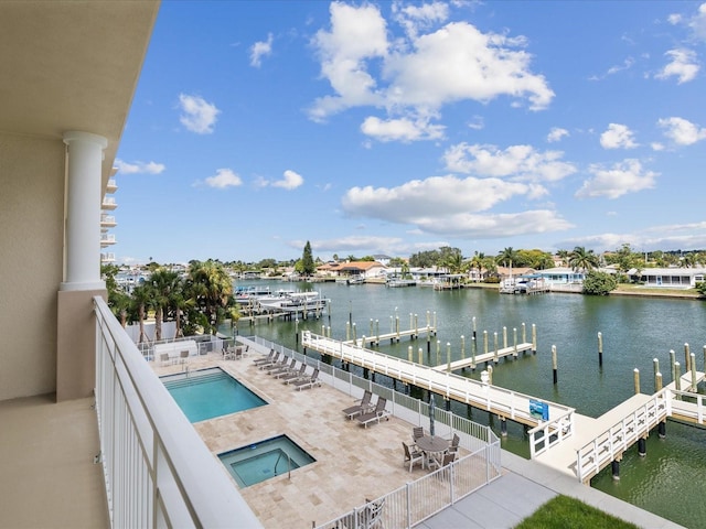 exterior space featuring a water view, a patio area, and a community pool