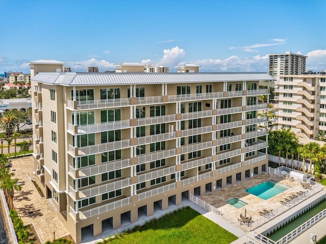 view of building exterior featuring a community pool