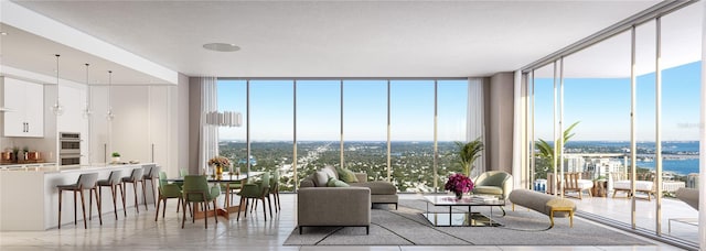 living room featuring a wall of windows and a water view