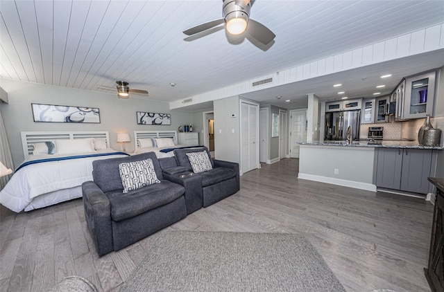 living room with ceiling fan, dark wood-type flooring, and wood ceiling