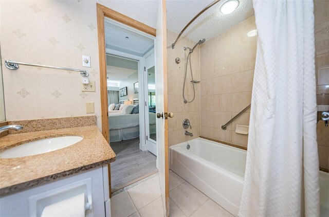 bathroom featuring vanity, a textured ceiling, shower / bath combo, and wood-type flooring