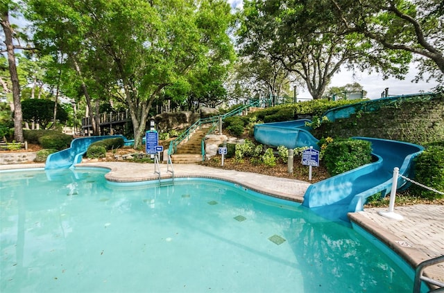 view of pool with a water slide