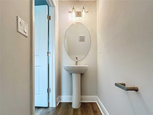 bathroom featuring visible vents, baseboards, and wood finished floors