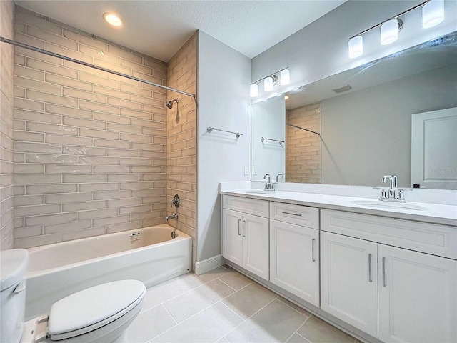 bathroom with tile patterned flooring, shower / bath combination, toilet, and a sink