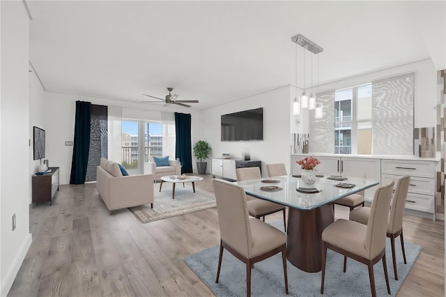 dining area featuring ceiling fan and light wood-type flooring