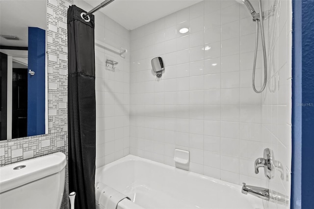 bathroom with shower / tub combo with curtain and toilet