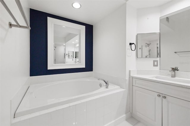 bathroom featuring vanity, shower with separate bathtub, and tile patterned flooring