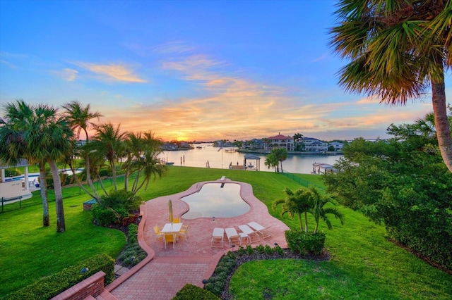 view of home's community featuring a patio, a yard, and a water view