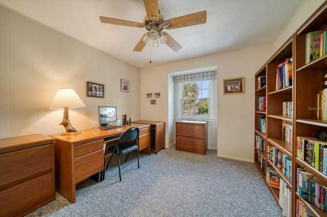 carpeted office space featuring ceiling fan