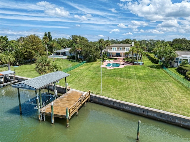 view of dock featuring a water view and a yard