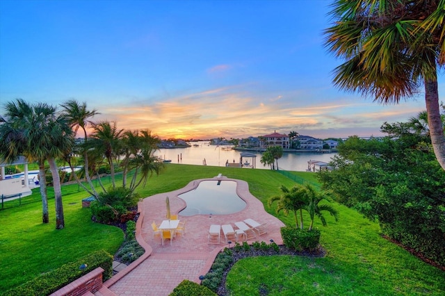 view of nearby features featuring a patio area, a yard, and a water view