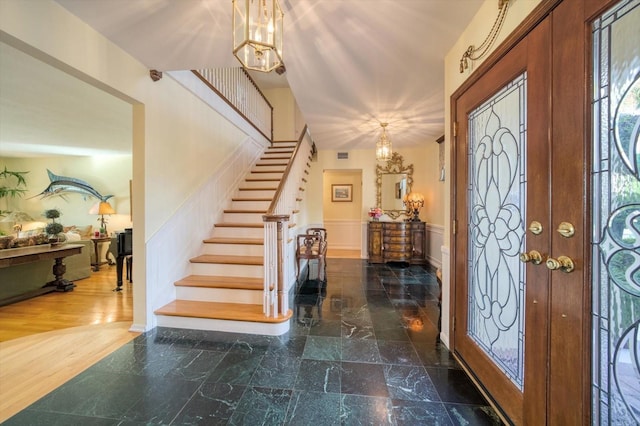 tiled foyer featuring a chandelier