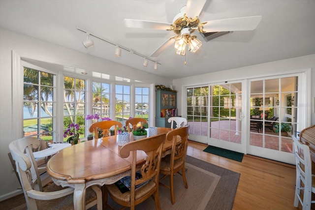 dining room featuring ceiling fan, rail lighting, and hardwood / wood-style flooring