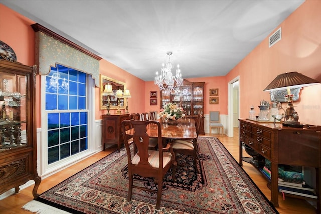 dining room with an inviting chandelier and light wood-type flooring