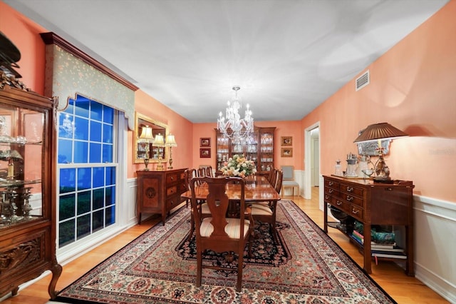 dining area featuring a chandelier and light hardwood / wood-style flooring