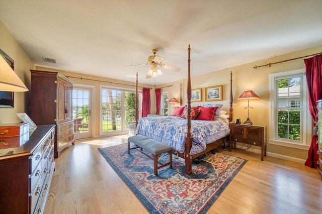 bedroom featuring light wood-type flooring, ceiling fan, access to exterior, and multiple windows