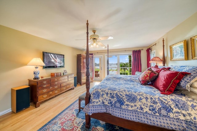 bedroom featuring light hardwood / wood-style flooring, ceiling fan, and access to outside