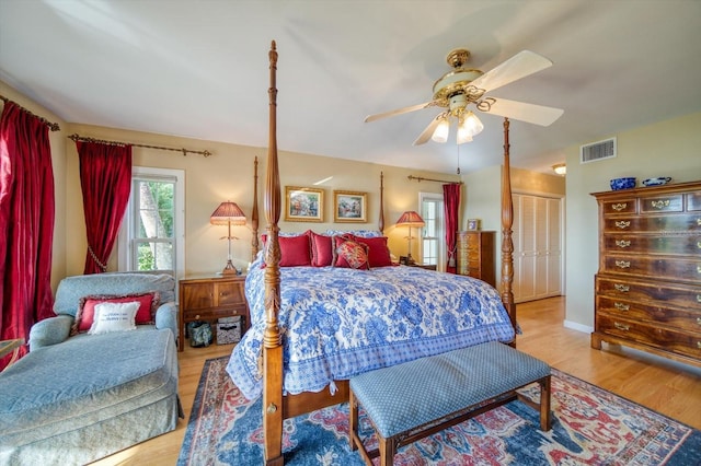 bedroom featuring wood-type flooring, ceiling fan, and a closet