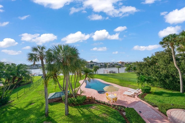 surrounding community with a water view and a lawn