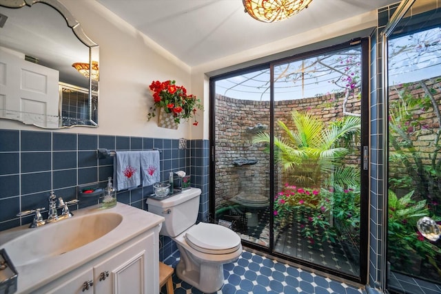 bathroom with a wealth of natural light, vanity, tile walls, and backsplash