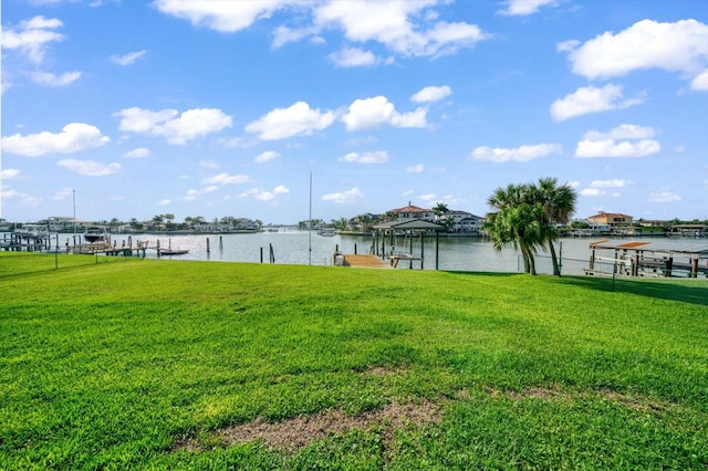 view of yard with a boat dock and a water view